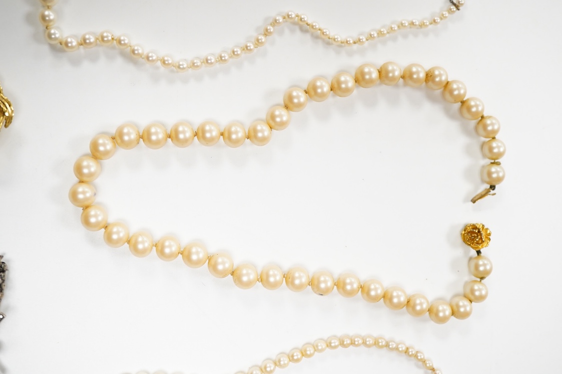 Two single strand graduated cultured pearl necklaces, one with a single stone rose cut diamond set 9ct white metal clasp, 42cm, together with a simulated pearl necklace and three assorted costume brooches.